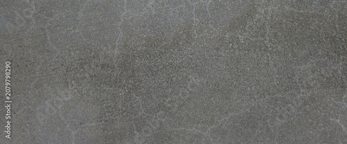 Dark gray concrete texture with subtle cracks, industrial cement wall background, charcoal stone surface for architectural design and overlays