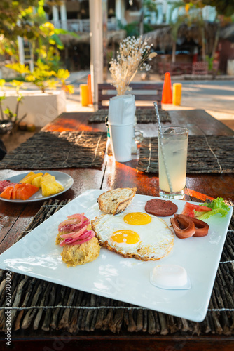 Traditional Dominican Los Tres Golpes breakfast, featuring mang?, fried eggs, fried cheese, and salami 