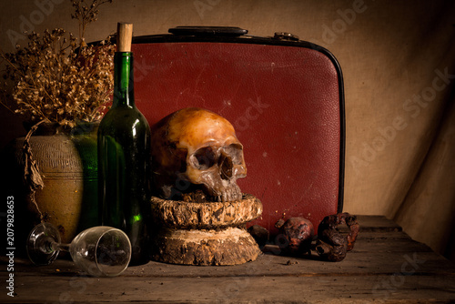 Human skull and flower vase old treasure on wooden table background, Still life concept