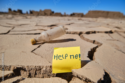 Fotografie Help me message on cracked earth showing drought concept