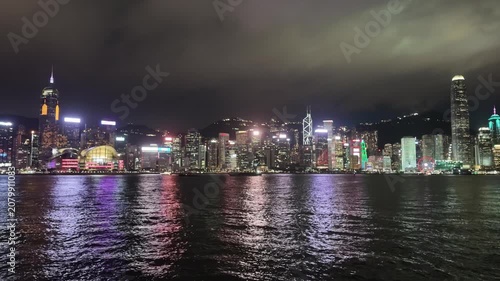 A captivating night view of Hong Kong's skyline, featuring the International Finance Centre and iconic buildings under a dramatic overcast sky