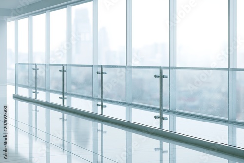 Modern minimalist interior corridor with large windows and glass railing