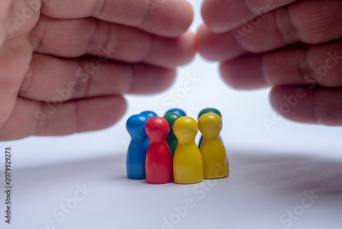 Protection and security concept with hands shielding a team