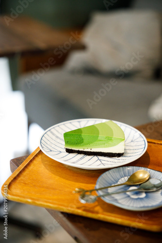 Green tea cake pie with gradient layered in cafe.