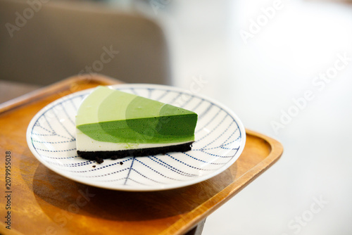 Green tea cake pie with gradient layered in cafe.