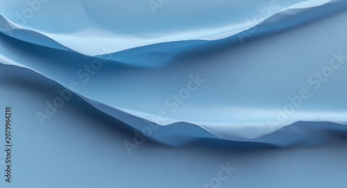 soft layered blue paper sheets with gentle folds and shadows forming abstract wave-like shapes, evoking calm and serenity