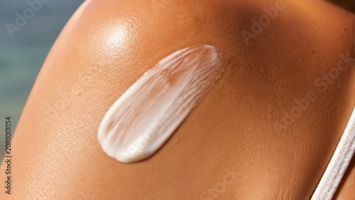 Shoulder skin with cream applied in closeup body shot