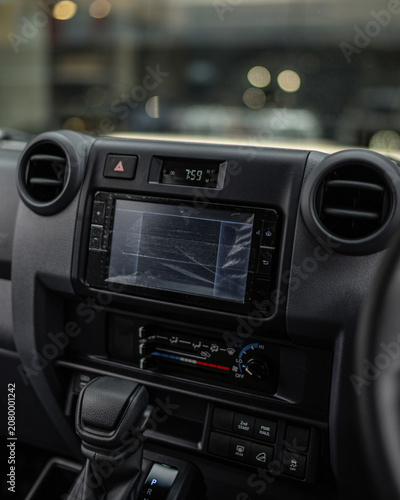 Modern car dashboard interior with digital infotainment screen.