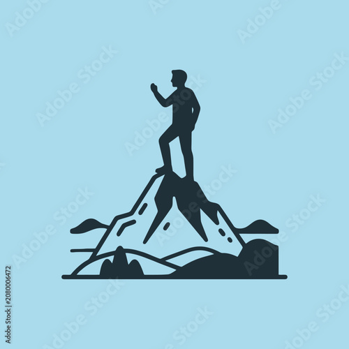 A silhouette of a man standing on a mountain peak