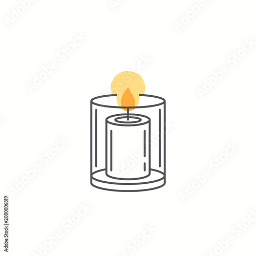 A burning candle sits inside a glass jar