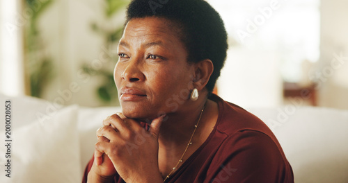 Photos Thinking, serious or black woman in home with nostalgia, wondering mindset or contemplating on past memory