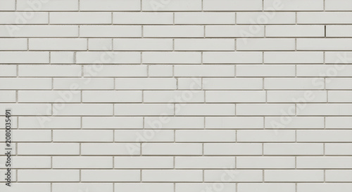 A close-up view of a white brick wall with gray mortar lines