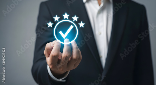 Businessman in suit presents glowing checkmark and stars on finger