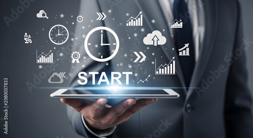 Businessman holding tablet with start icons floating above