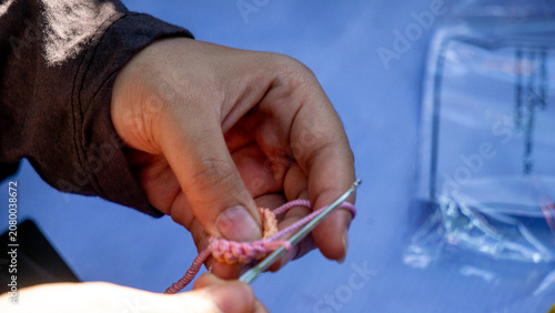Creating items (lipstick holder) using the craft of knitting. An activity in leisure time.