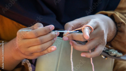 Creating items (lipstick holder) using the craft of knitting. An activity in leisure time.