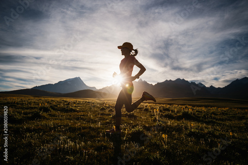 Trail runner running on the high altitude grassland mountain top