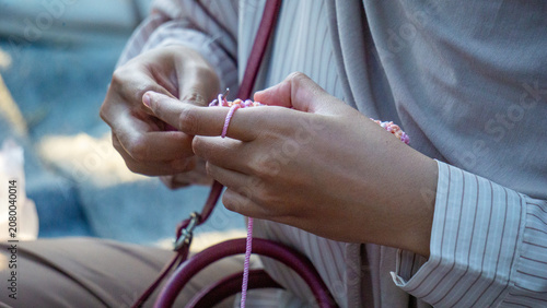 Creating items (lipstick holder) using the craft of knitting. An activity in leisure time.