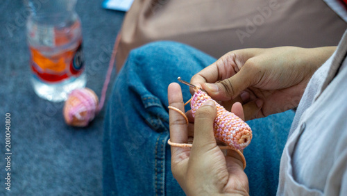 Creating items (lipstick holder) using the craft of knitting. An activity in leisure time.