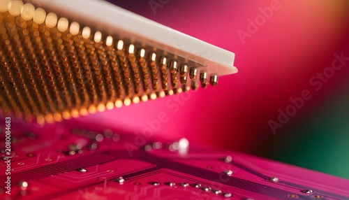 Edge view of golden processor array pins. High performance hardware and hardware component testing. Computer CPU chip mounting onto a pink electronic motherboard surface