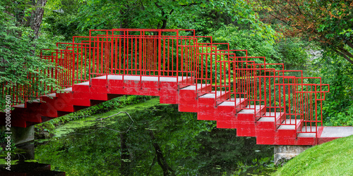 Red bridge spanning small canal in Dow gardens, Michigan