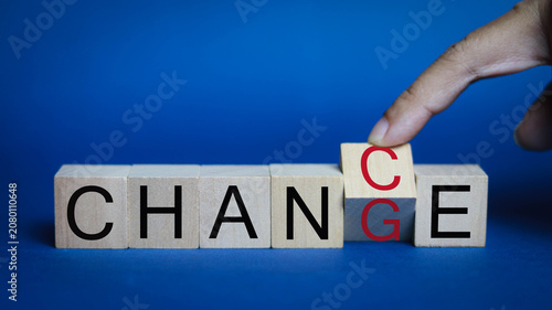 Fotografie Business change management concept with a hand replacing a wooden block to compl