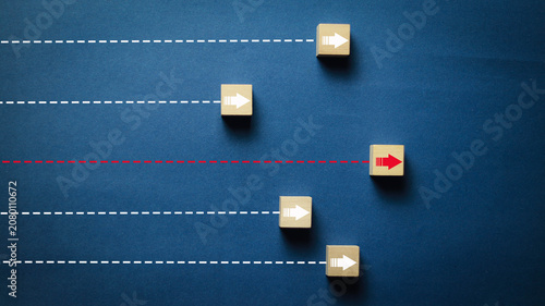 Fotografía Creative business strategy concept featuring wooden arrow blocks on parallel pat