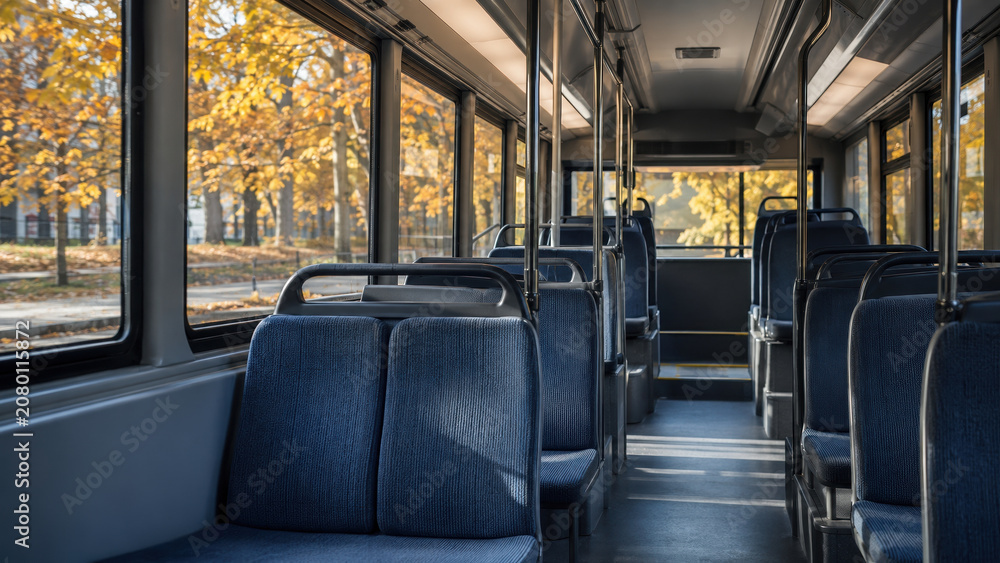 Fototapeta premium Empty city bus interior with autumn trees outside