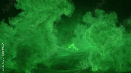 Abstract green smoke and dust particles billowing on a dark background