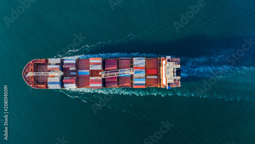cargo container ship fully loaded transportaion colorful shipping containers navigates through deep blue ocean waters, leaving a wake as it transports goods global maritime logistics 