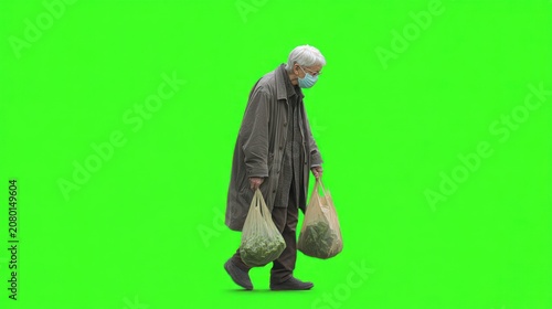 Elderly person in a face mask, carrying bags of produce
