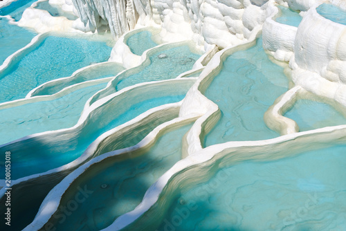 Blue mineral pools on white limestone terraces