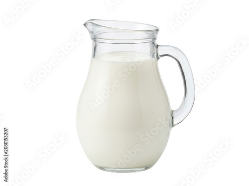 Clear glass pitcher full of fresh white milk