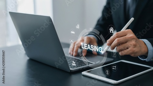 Businessman using laptop for real estate leasing service with digital icons overlay