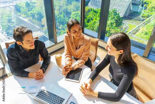 Group of Multiethnic business people discussing business plan at meeting room. Businessman and businesswoman having a discussion in modern office.