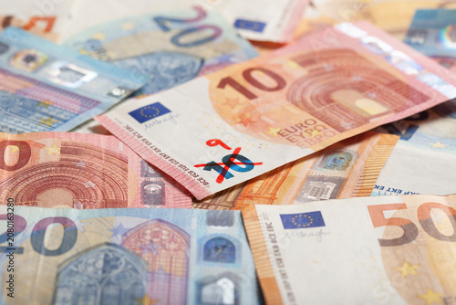 Ten euro banknote with number 9 written on it symbolizing devaluation of currency