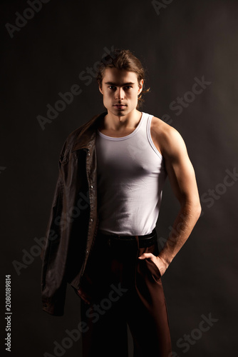 Brooding Gaze of a Young Man With Jacket, Captivating Studio Portrait