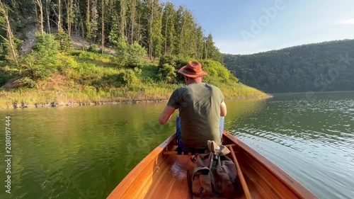 Man fishing on a freshwater lake from canoe