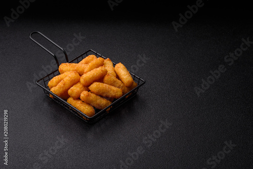 Mozzarella cheese sticks, breaded and fried with salt and tomato sauce, for takeaway. Cheese sticks