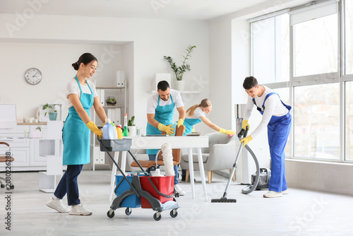 Female Asian janitor carryi...
