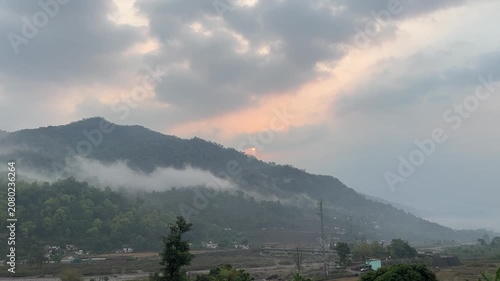 Landscape of hills surrounded by clouds during the early morning. Arial view of nature. River in the field. Nature and travel concept.