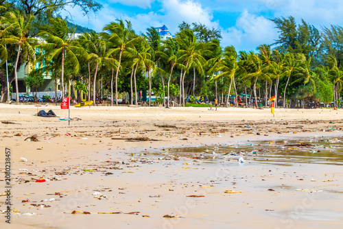 Tropical beach disaster with floating plastic waste and disgusting polluted shoreline Thailand.