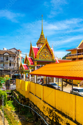 Golden Buddhist Wat Suwankeereewong Temple panorama blue sky in Thailand.
