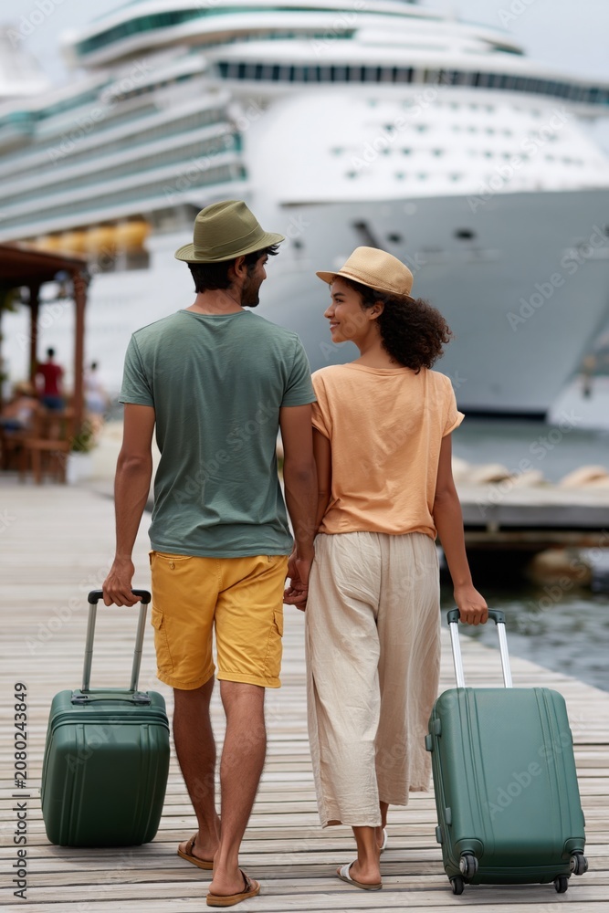 Fototapeta premium Couple walking on dock toward cruise ship with suitcases for travel banner and vacation background