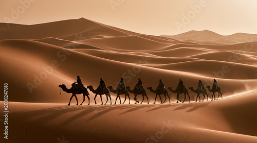 A cinematic wide-angle capture of a nomadic caravan forming a silhouette against the vast sand dunes of a desert at sunset.