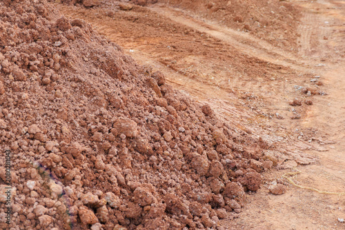 Soil dirt pile earth ground on rough construction site with tire track