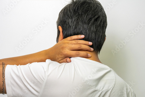 Photos Person holding sore neck, occipital pain from stress and overwork, medical treatment and rehabilitation concept