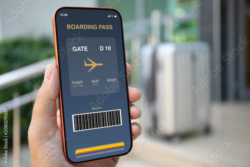 Man hand holding phone with digital boarding pass airport luggage