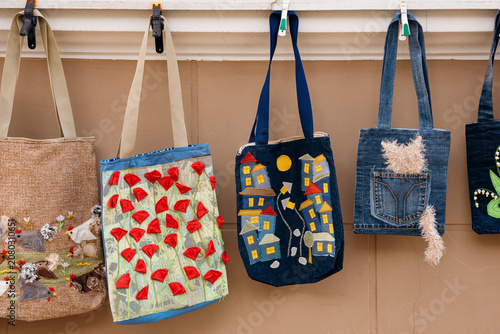 Фотография Eco conscious fashion upcycled denim bags handmade craft.