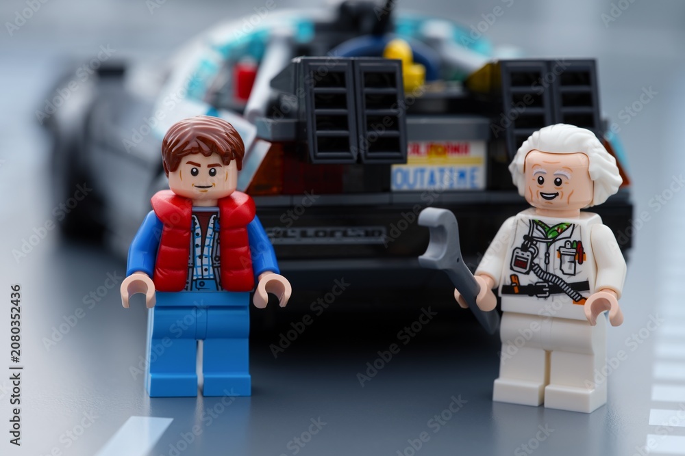 Obraz premium Tambov, Russian Federation - June 20, 2026 Lego minifigures of Marty McFly and Doc Brown standing in front of the DeLorean time machine car from Back to the Future.